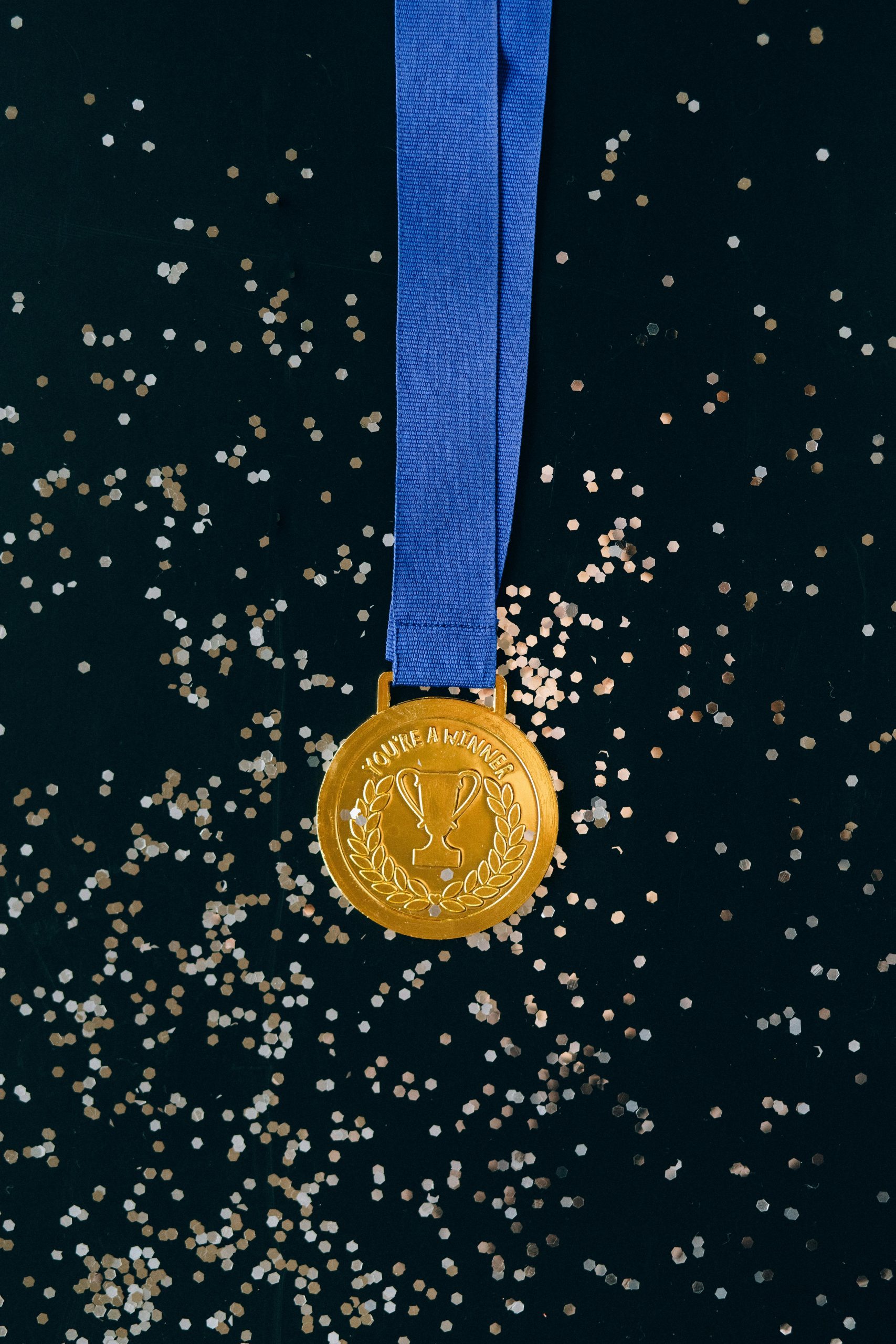 Close up shot of a gold medal on a black surface